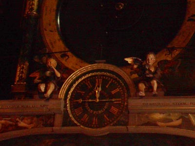The clock reads 12:15 and 11:45 for 2 time zones